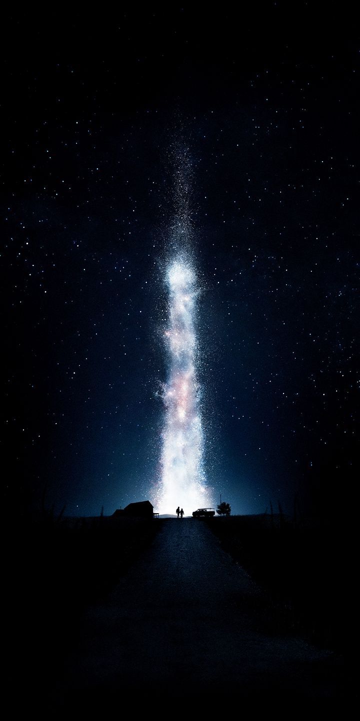 the night sky is filled with stars and light streaks as people stand in front of it