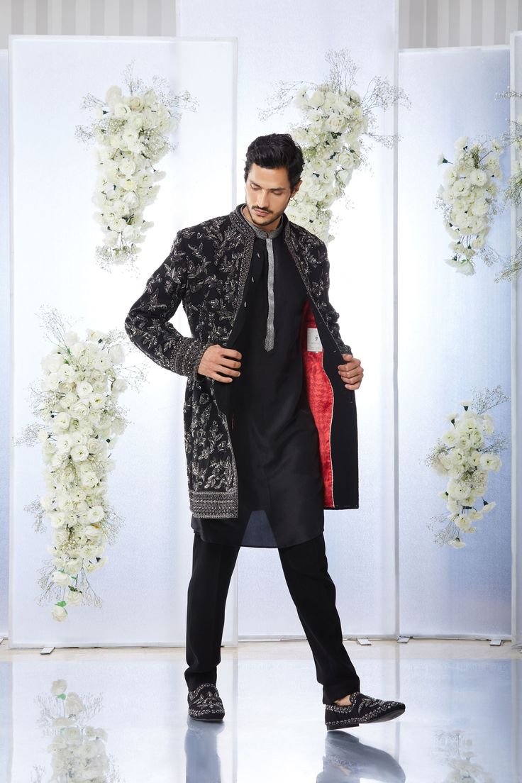 This black short sherwani set features tonal all over zardosi embroidery on a japanese base. It is paired with a black silk kurta and a japanese trouser. Complimenting stole and footwear is also available. From Seema Gujral's Tuscan Summer collection. DELIVERY TIMEPlease allow 4 months for your outfit to arrive.FABRIC DETAILSJapaneseProfessional cleaning only. Black Embroidered Bandhgala Kurta, Traditional Black Bandhgala With Chikankari Embroidery, Black Bandhgala Straight Kurta, Black Nehru Jacket With Zari Work, Designer Black Kurta With Naqshi, Black Straight Kurta Bandhgala For Festive Season, Festive Black Straight Kurta Bandhgala, Black Sherwani With Chikankari Embroidery, Designer Black Embroidered Kurta