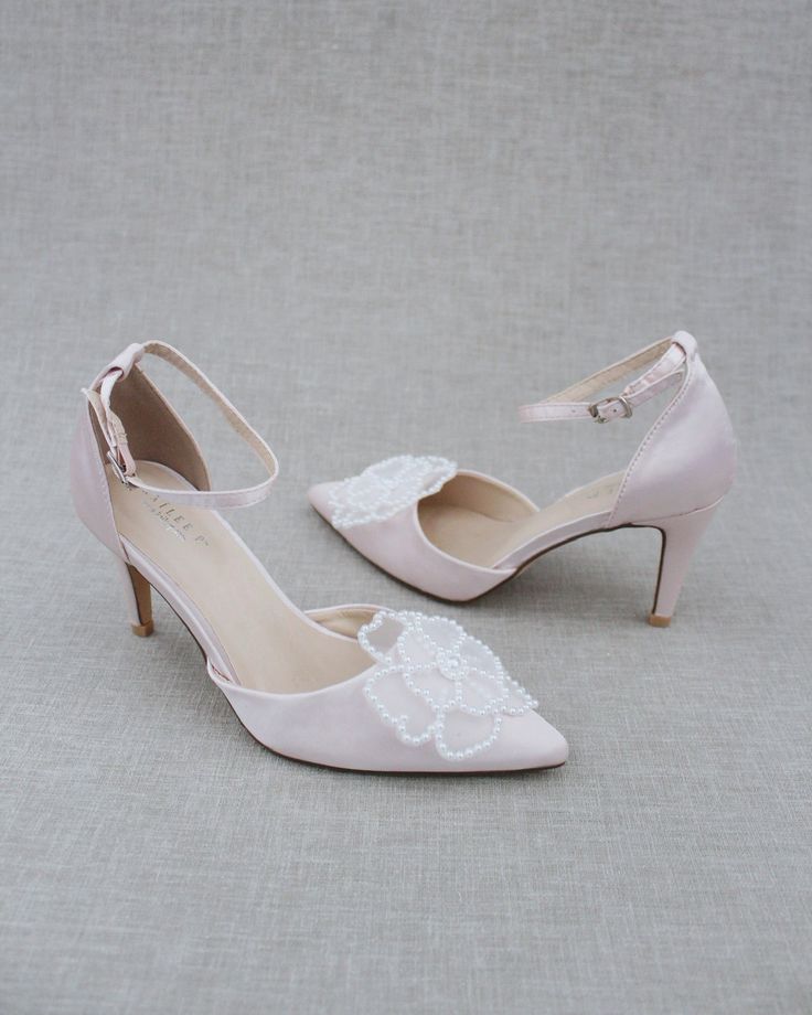 Classic satin pointy toe heels adorned with large white pearl primrose flower applique. Sleek and glamour is a great combination and will definitely be a favorite. DETAILS: HEELS: 3 inches COLORS AVAILABLE: Dusty Pink, Light Blue, Black, Champagne, Ivory, and White UPPER: Synthetic upper and lining MATERIALS: Manmade outsole ORIGIN: Imported STYLE NAME: BELL Low Heel Satin Wedding Heels, Satin Low Heel Wedding Heels, Elegant Satin Wedding Shoes, Satin Wedding Shoes With 4-inch Heel, Satin Closed-toe Wedding Shoes, High Heel Satin Wedding Shoes, Satin High Heel Wedding Shoes, Satin Closed Toe Wedding Shoes, Elegant Embellished Wedding Shoes For Bridesmaid