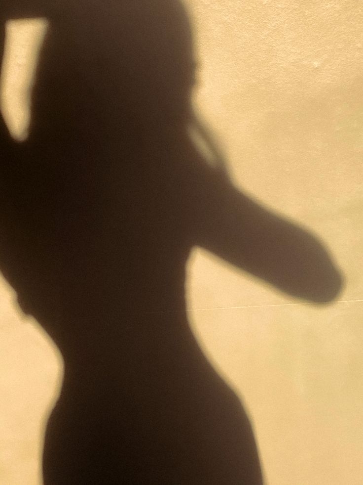 the shadow of a woman talking on her cell phone