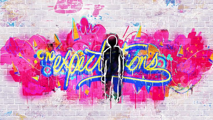 a person standing in front of a brick wall with graffiti on it and the words happy birthday written below