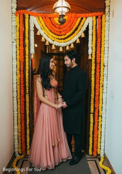 a man and woman standing in front of a doorway