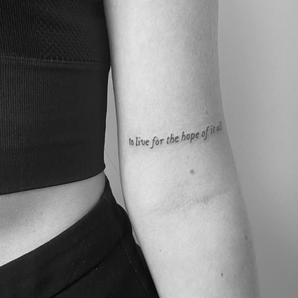 a woman with a tattoo on her arm that says i'm live for the hope of life