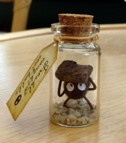 a small glass jar filled with rocks and sand