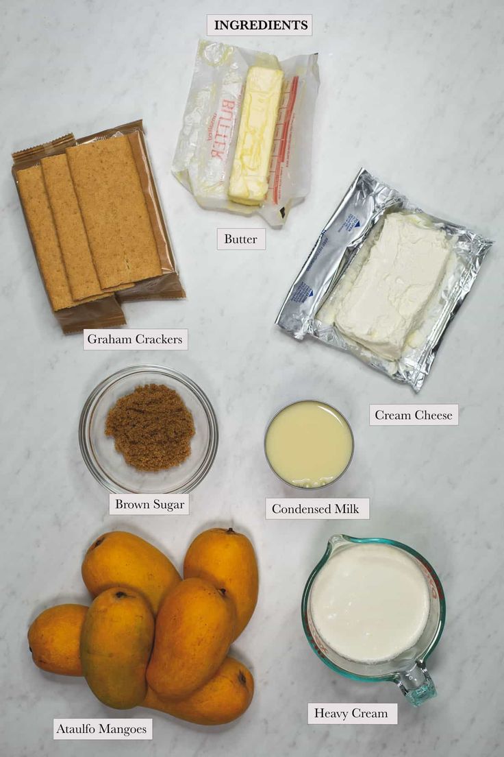 the ingredients needed to make an orange smoothie laid out on a white counter top