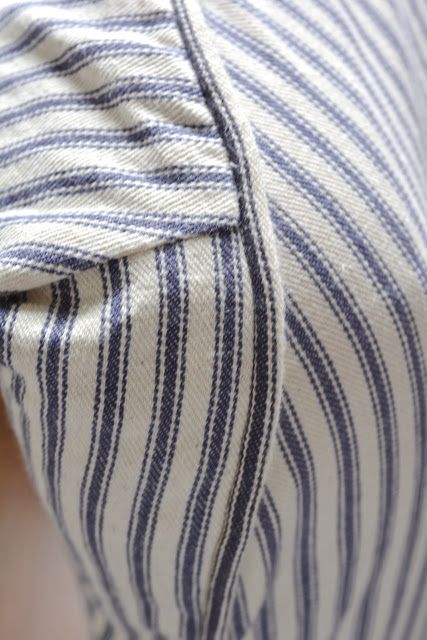 a close up view of a blue and white striped shirt on someone's chest