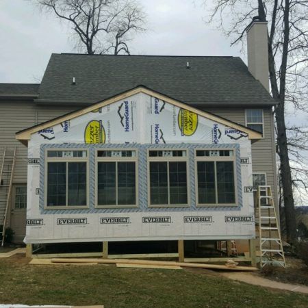 a house being built with windows and siding