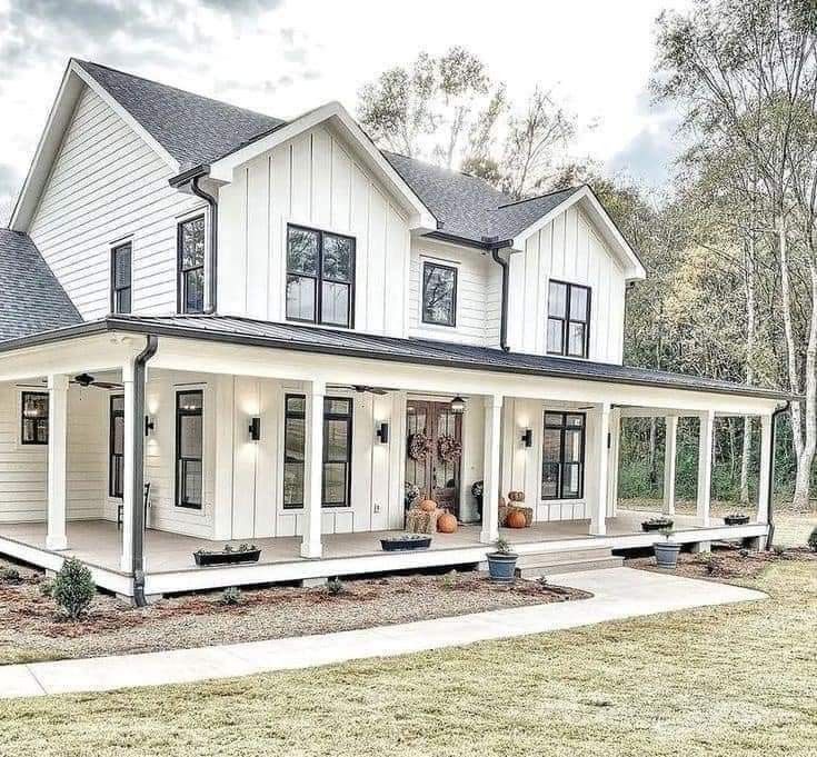 a large white house with black trim and windows