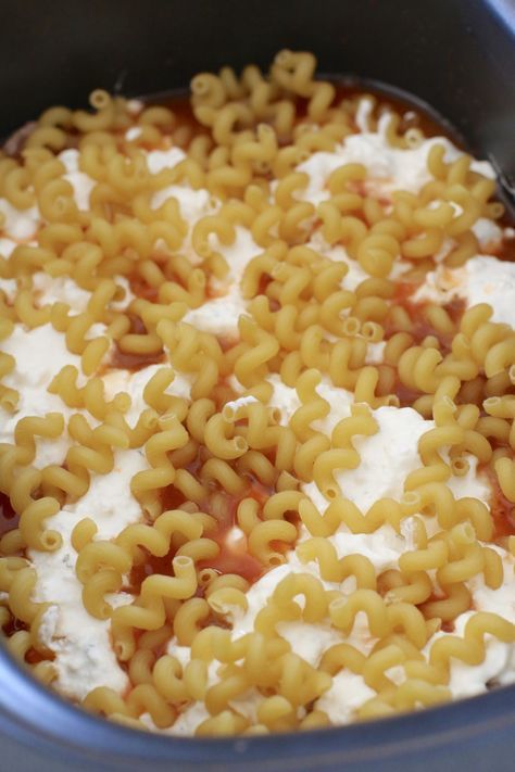 macaroni and cheese is being cooked in a pot