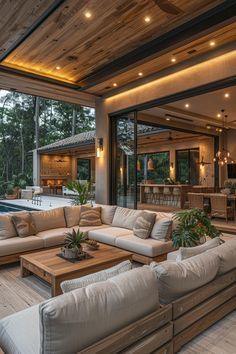 a living room filled with furniture next to a swimming pool