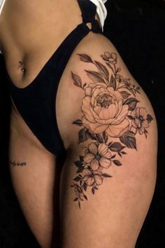 a woman's thigh with flowers on it