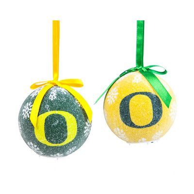 two easter eggs with the number six painted on them, hanging from green and yellow ribbons