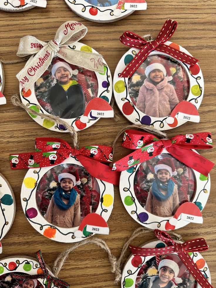 christmas ornament ornaments with family pictures on them hanging from twine strings and ribbons