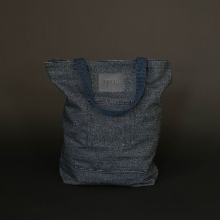 a gray bag sitting on top of a black table