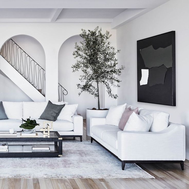 a living room filled with furniture and a staircase