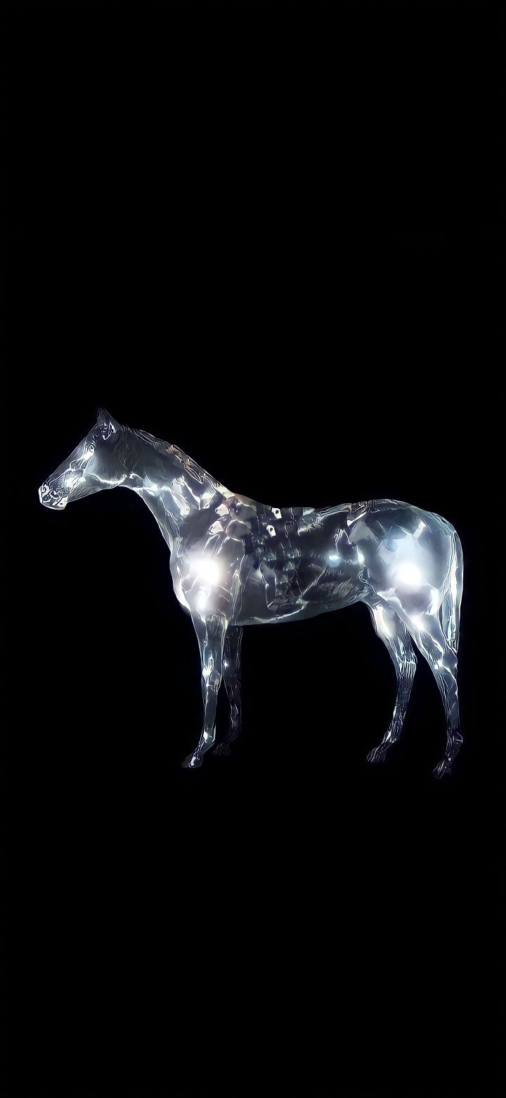 a glass horse standing in the dark with lights on it's head and neck