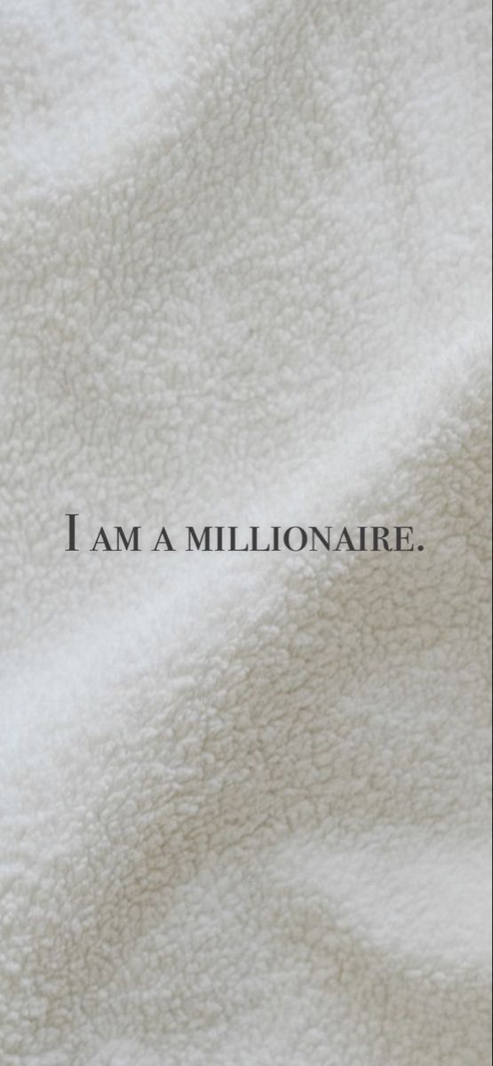 the words i am a millionaire are written in black on a white blanket