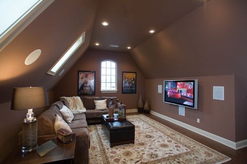 a living room filled with furniture and a flat screen tv mounted to the side of a wall