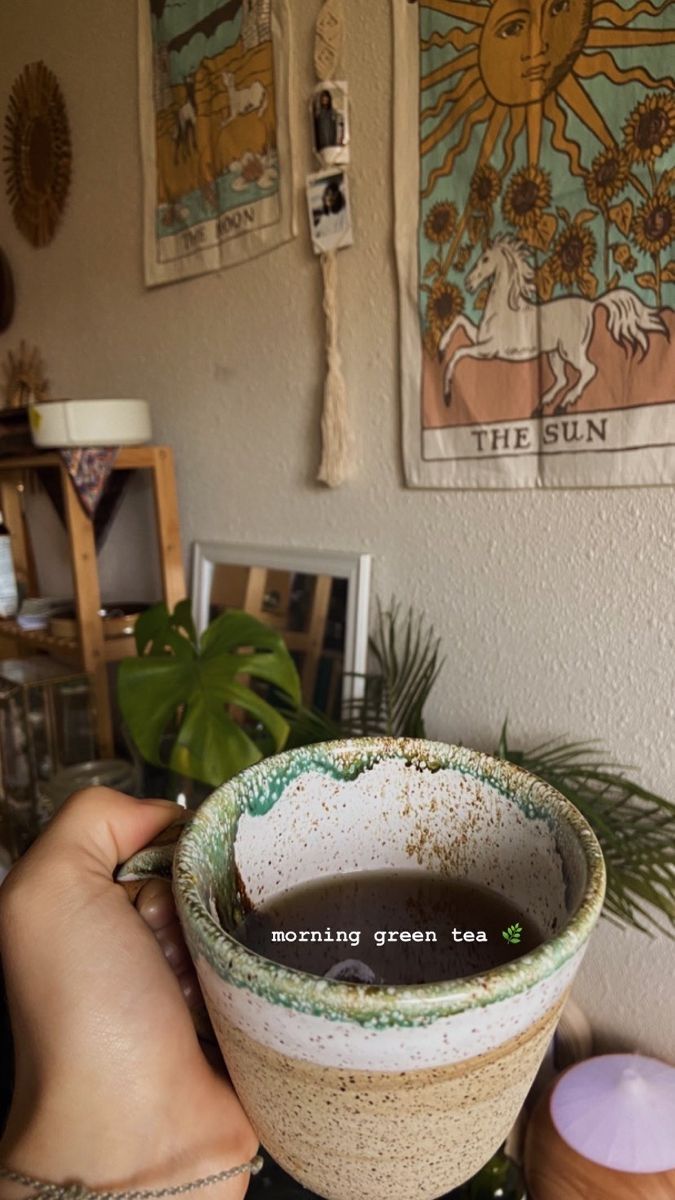 a person holding up a cup filled with liquid