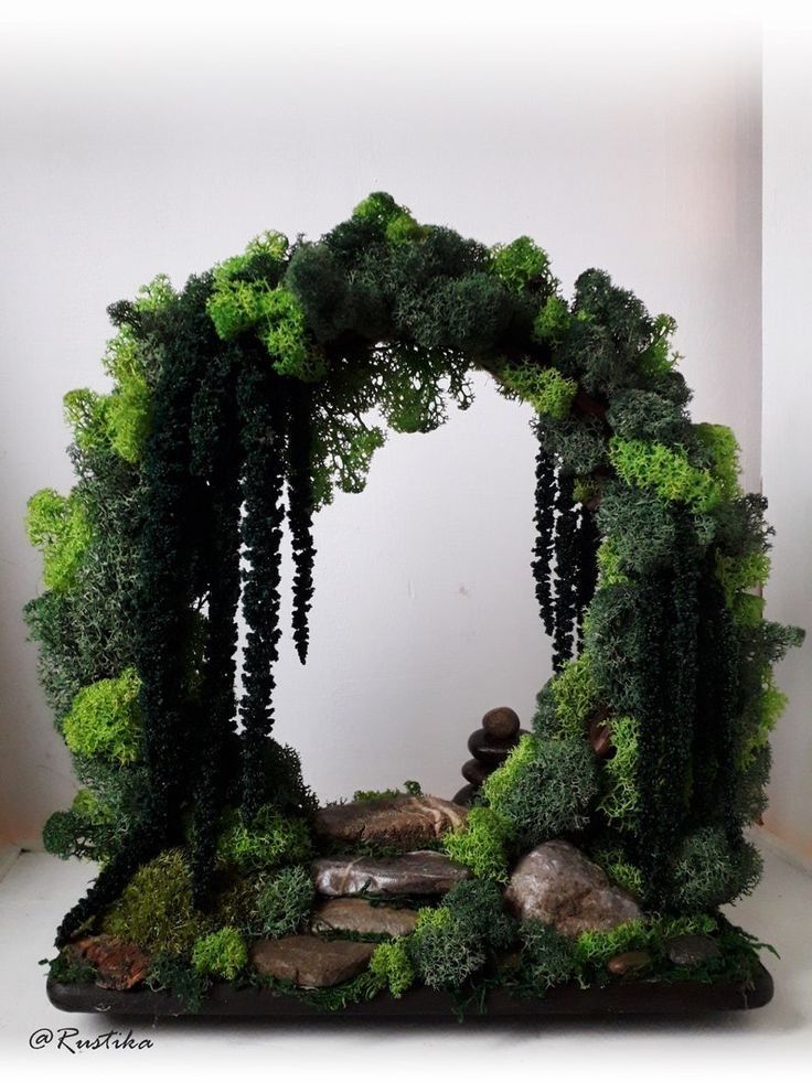 an arch made out of plants and rocks