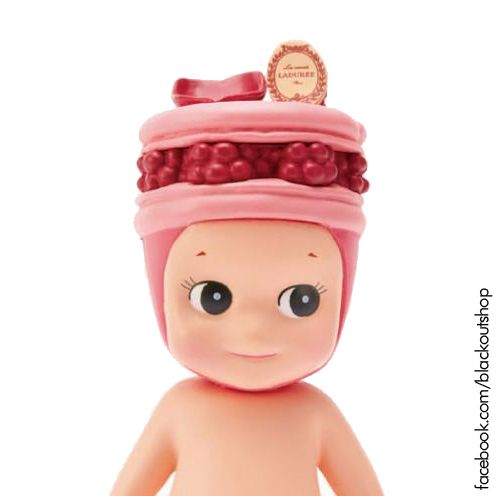 a small doll with a pink hat on top of it's head and eyes