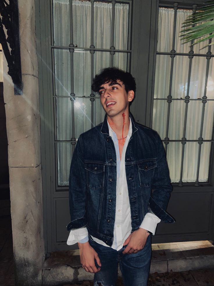 a young man standing in front of a door