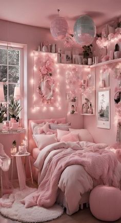 a pink bedroom with lights and decorations on the walls