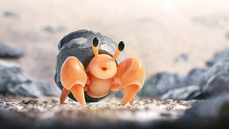 a small toy crab is sitting on the ground next to some rocks and gravel,