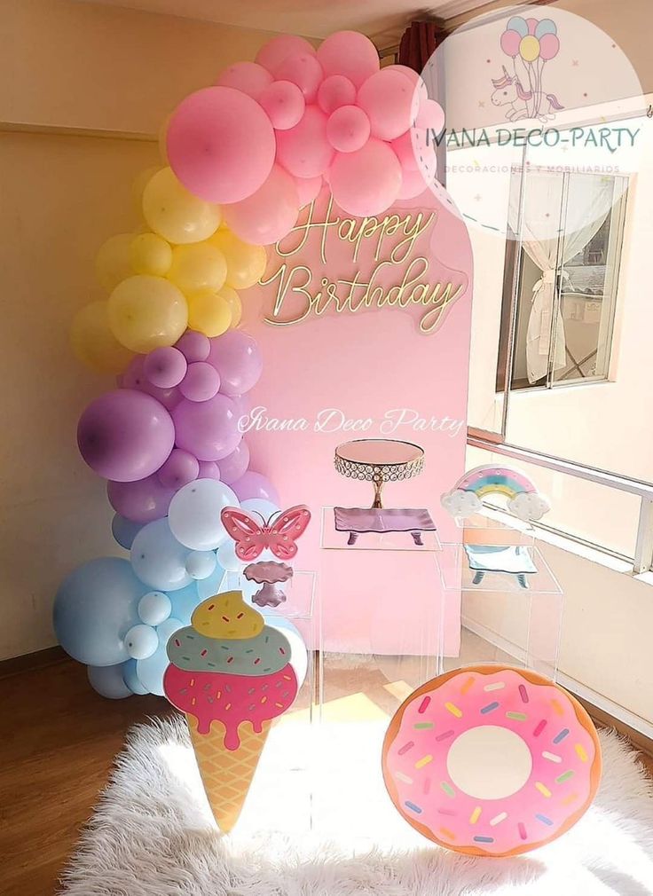 a birthday party with balloons and donuts