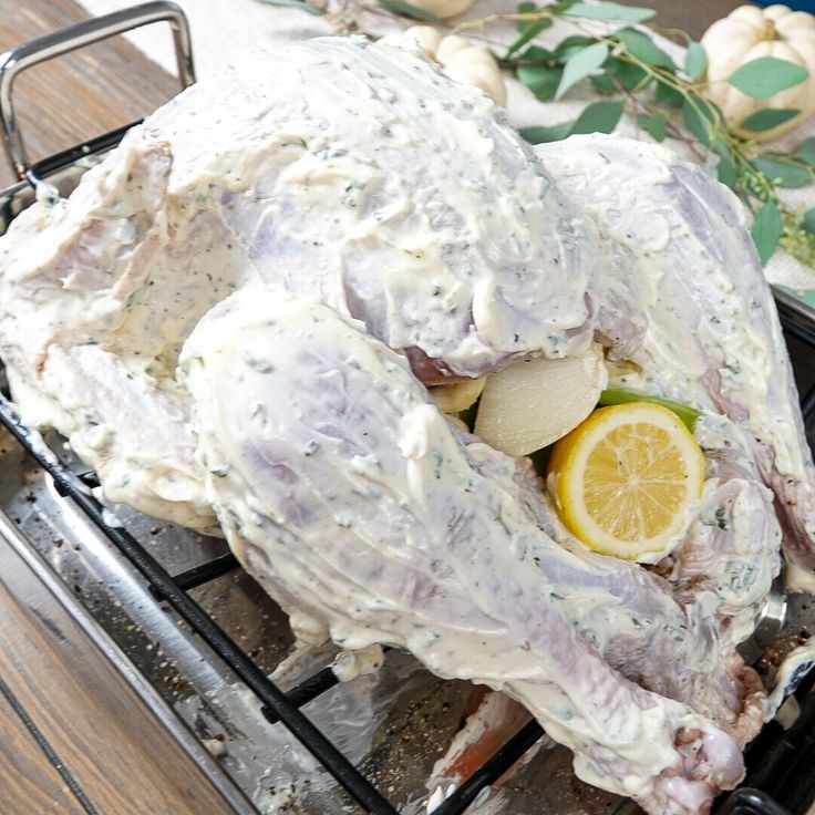 a whole chicken on a grill with lemons and potatoes