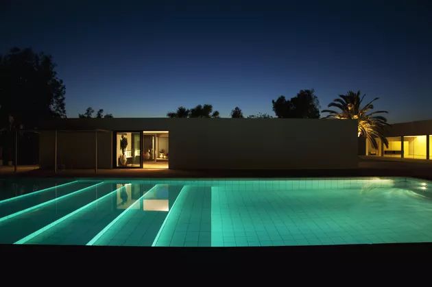 an empty swimming pool at night with lights on