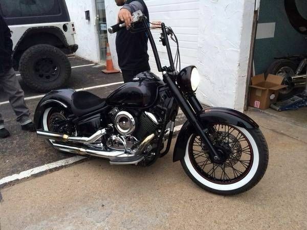 a man standing next to a parked motorcycle