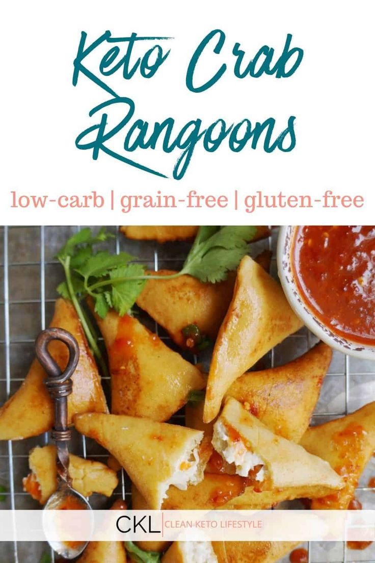 keto crab rangoons on a cooling rack with dipping sauce and garnishes