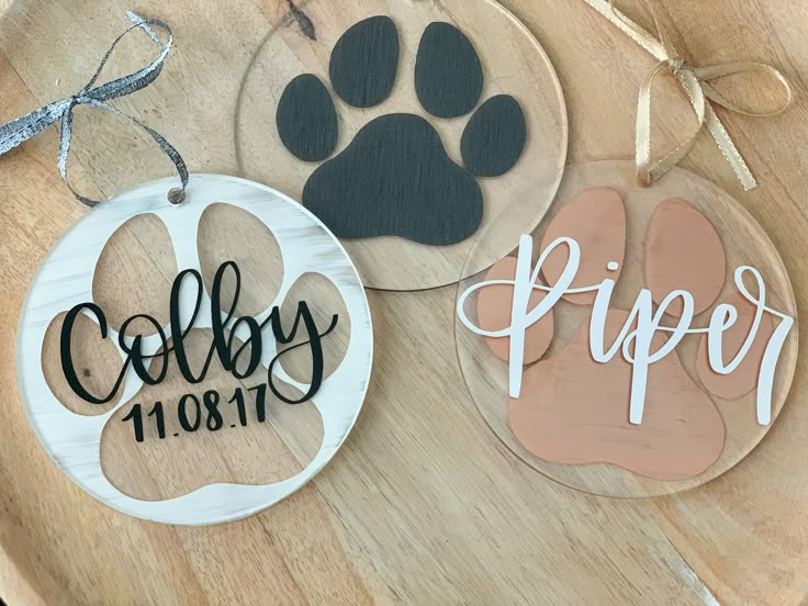 three wooden ornament with dog's name and paw prints