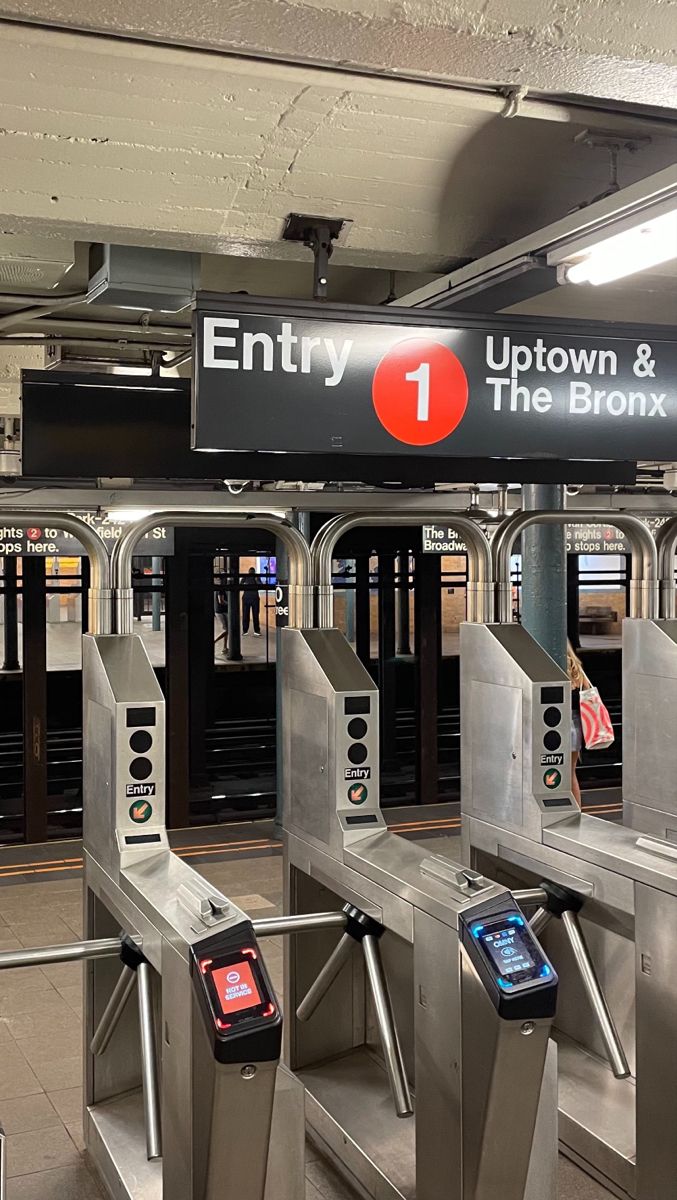 an empty subway station with the doors open and electronic turnsigns in front of them