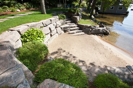 a stone retaining wall next to the water