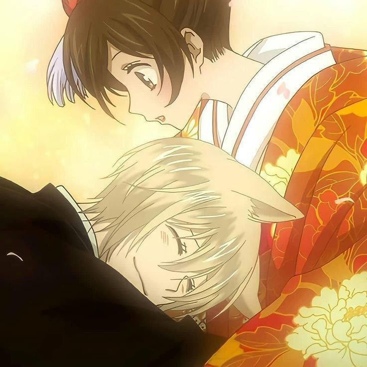 two anime characters are hugging each other in front of an orange and yellow flowered background