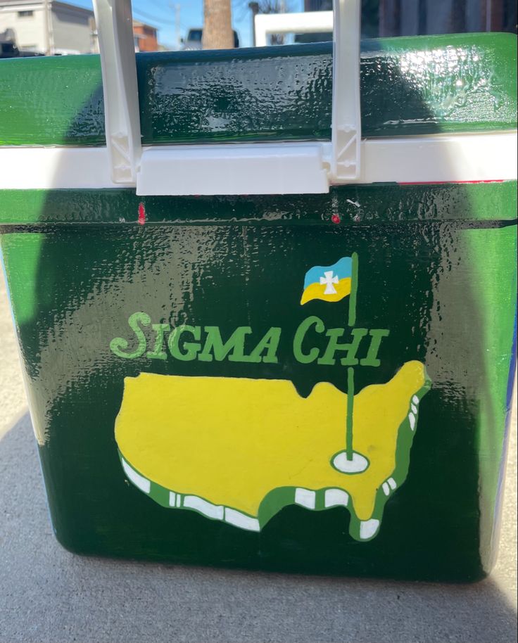 a green and yellow cooler with the word stigma chit on it's side