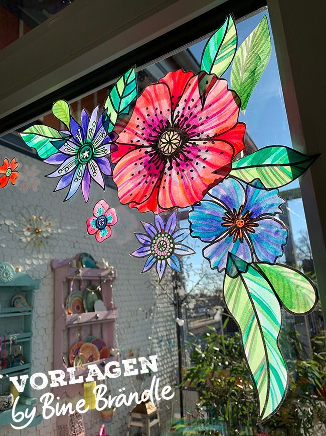 the window is decorated with colorful flowers and leaves