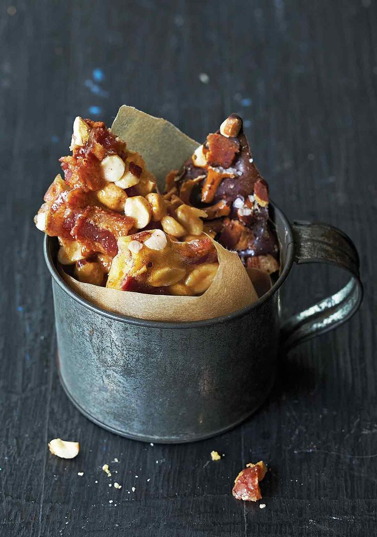 a metal cup filled with food on top of a table