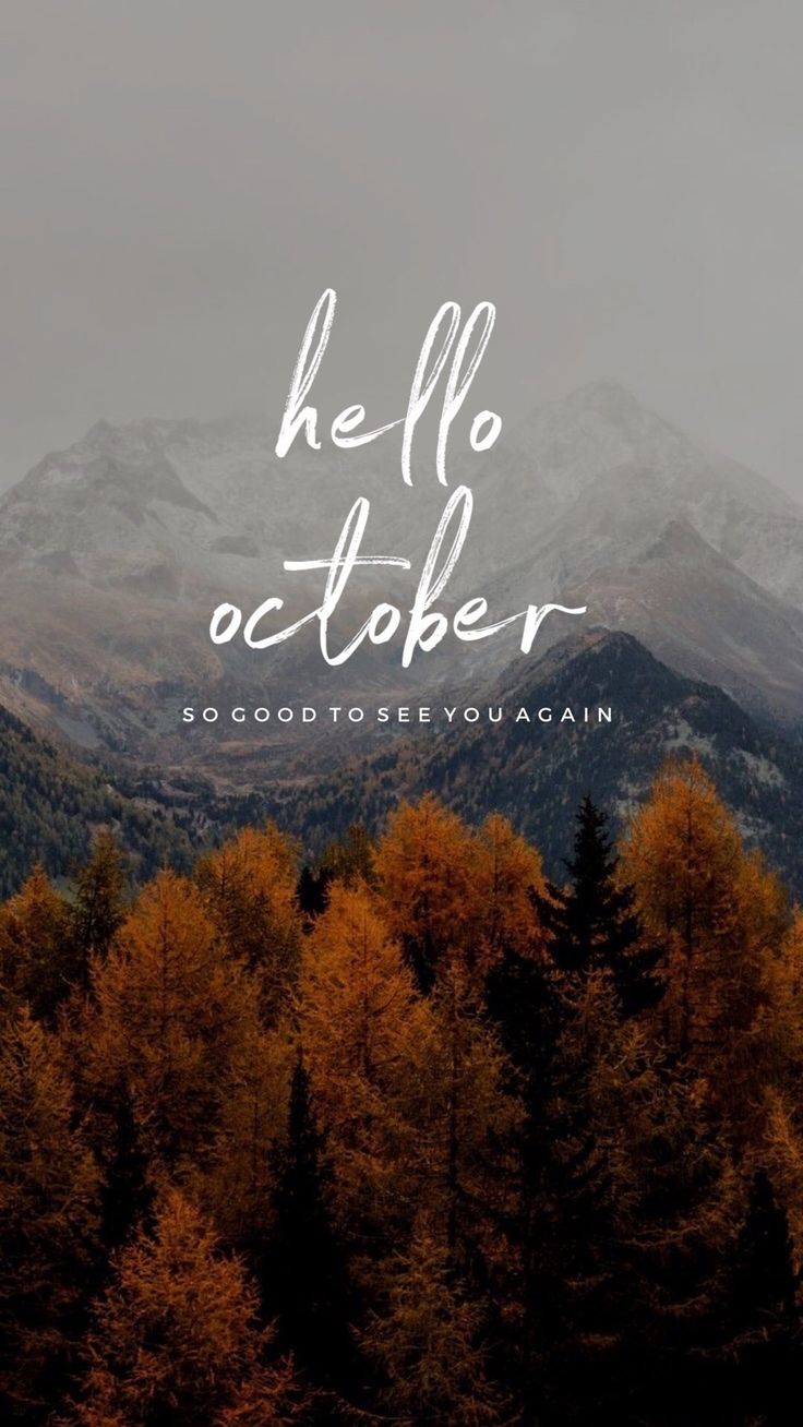 the words hello october are written in white on top of some trees and mountain tops