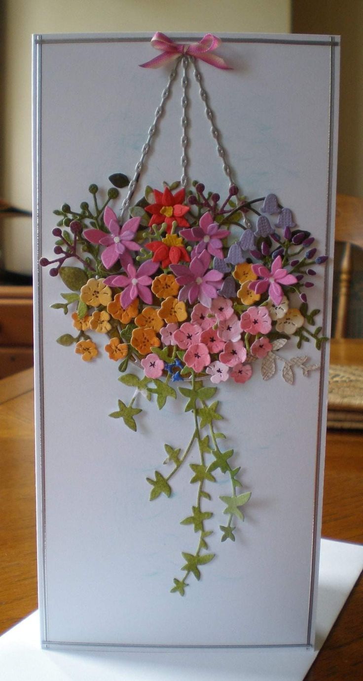 a card with flowers hanging from it's side