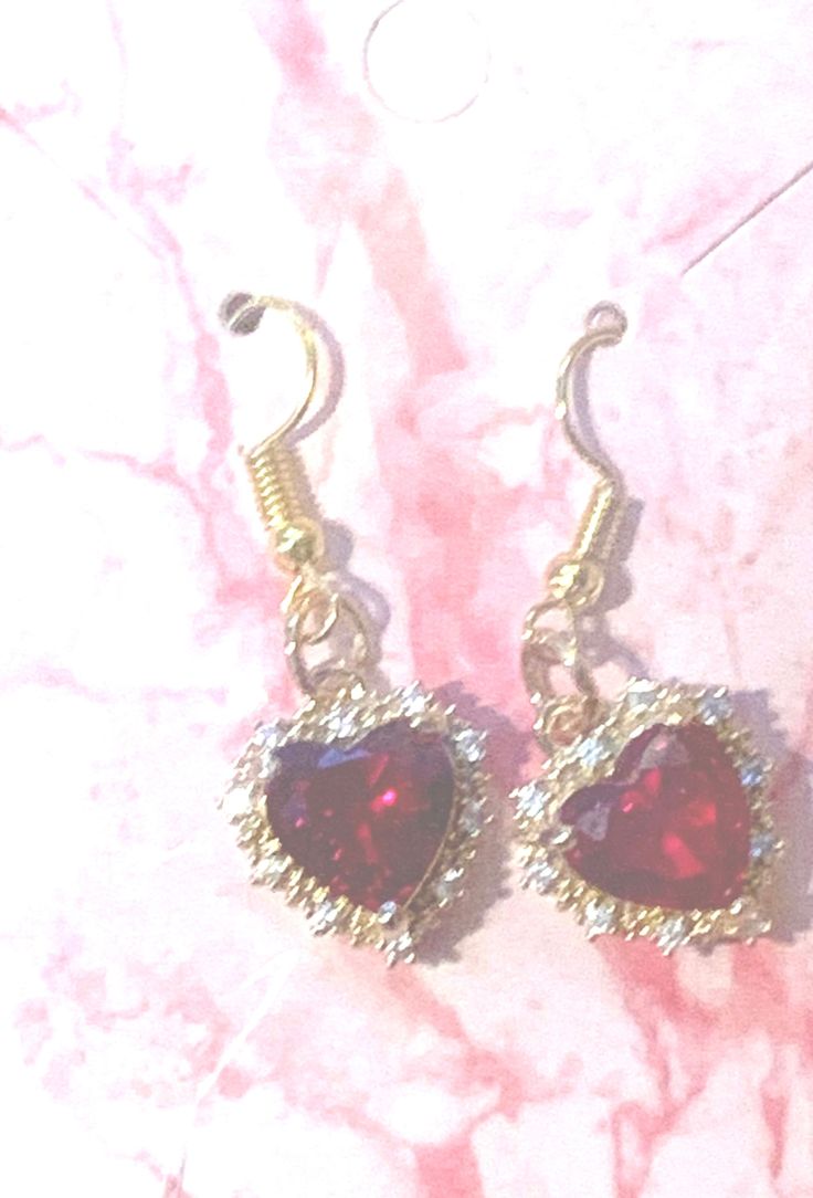 Red Heart with Rhinestones sparkles in this gold setting the earrings dangle about 1.5". Gold Heart Earrings With Rhinestones For Valentine's Day, Elegant Rhinestone Heart Earrings As Gift, Gold Rhinestone Heart Earrings, Gold Heart Shaped Crystal Earrings For Party, Gold Heart-shaped Earrings With Rhinestones, Sparkling Gold Earrings For Valentine's Day, Gold Heart-shaped Jeweled Jewelry, Gold Jeweled Heart Jewelry, Gold Crystal Earrings For Valentine's Day