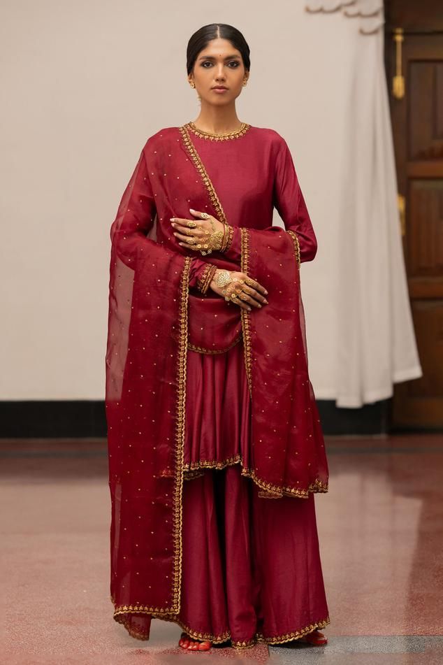 Burgundy anarkali with woven, floral sequin embroidery detailing. Paired with sharara and dupatta.
Components: 3
Pattern: Embroidered, Woven
Type Of Work: Floral
Neckline: Round
Sleeve Type: Full
Fabric: Kurta, Sharara: Munga Silk, Dupatta: Organza Silk
Color: Wine
Other Details: 
Embroidered dupatta
Model height: 5ft 7inches, wearing size S
Length: 39 inches
Occasion: Puja - Aza Fashions Burgundy Anarkali, Silk Kurta Set, Kurta Sharara, Embroidery Detailing, Silk Kurta, Sequin Embroidery, Embroidered Dupatta, Sharara Set, Buy Wine