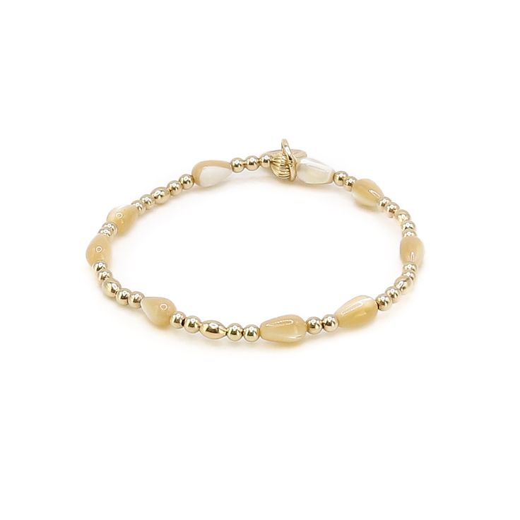 Crafted with 14k gold fill, they provide a luxurious look and feel without compromising durability. Perfect for adding a subtle, classic charm to bracelets, necklaces, and other jewelry pieces, these beads are a staple for timeless style. Neutral Accessories, Teardrop Beads, Beautiful Textures, Bracelet Stack, Holiday Collection, Stretch Bracelet, Timeless Style, Mother Of Pearl, Jewelry Pieces