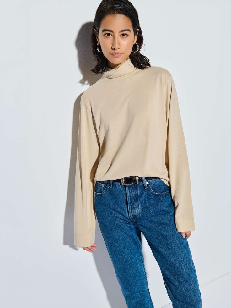 This versatile folded turtleneck top features side slits and a relaxed fit for that effortless cool factor without the fuss. (You might need every color). (This one comes in Champagne.) | Neo Top in Champagne | Ethical Essentials Solid Turtleneck Top With Relaxed Fit, Solid Color Relaxed Fit Turtleneck Top, Solid Relaxed Fit Turtleneck Top, Relaxed Fit Turtleneck Tops, Everyday Relaxed Fit Tops With Funnel Neck, Funnel Neck Tops With Relaxed Fit, Everyday Relaxed Fit Funnel Neck Tops, Relaxed Fit Funnel Neck Top For Everyday, Everyday Relaxed Fit Turtleneck Tops