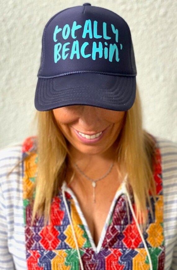 TOTALLY BEACHIN' in aqua on a navy trucker hat with interior french terry sweat band and adjustable snap back. Trendy Trucker Hat With Curved Bill For Beach, Trendy Curved Bill Trucker Hat For Beach, Spring Vacation Trucker Hat, Trendy Snapback Hat With Curved Bill For Beach, Trendy Curved Bill Snapback Hat For Beach, Casual Adjustable Baseball Cap For Beach Season, Trendy Spring Trucker Hat For Travel, Trucker Baseball Cap With Curved Bill For Beach, Adjustable Trucker Hat For Summer Travel