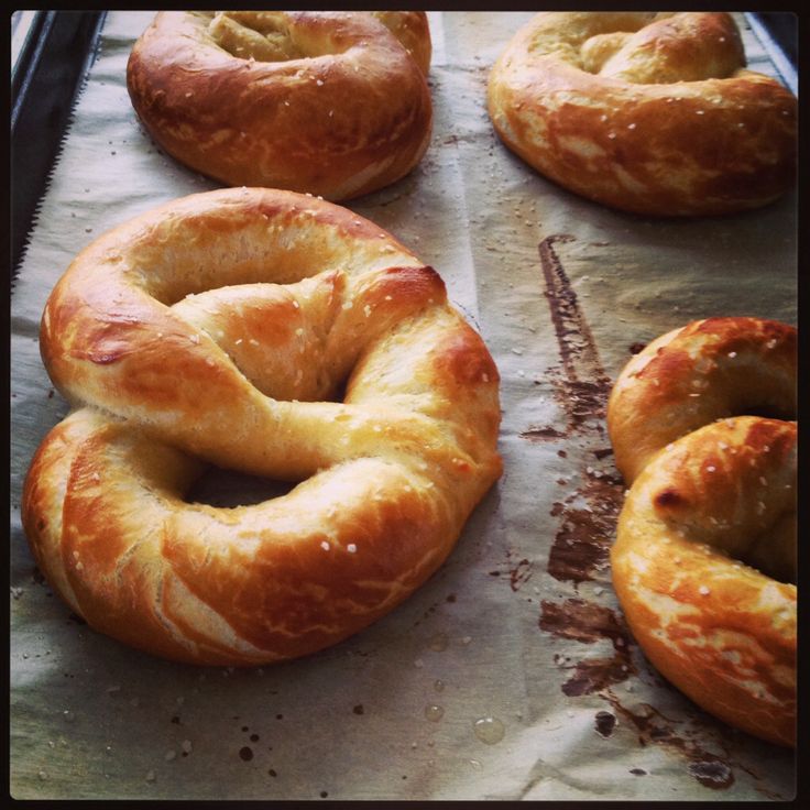 freshly baked bagels are lined up on wax paper