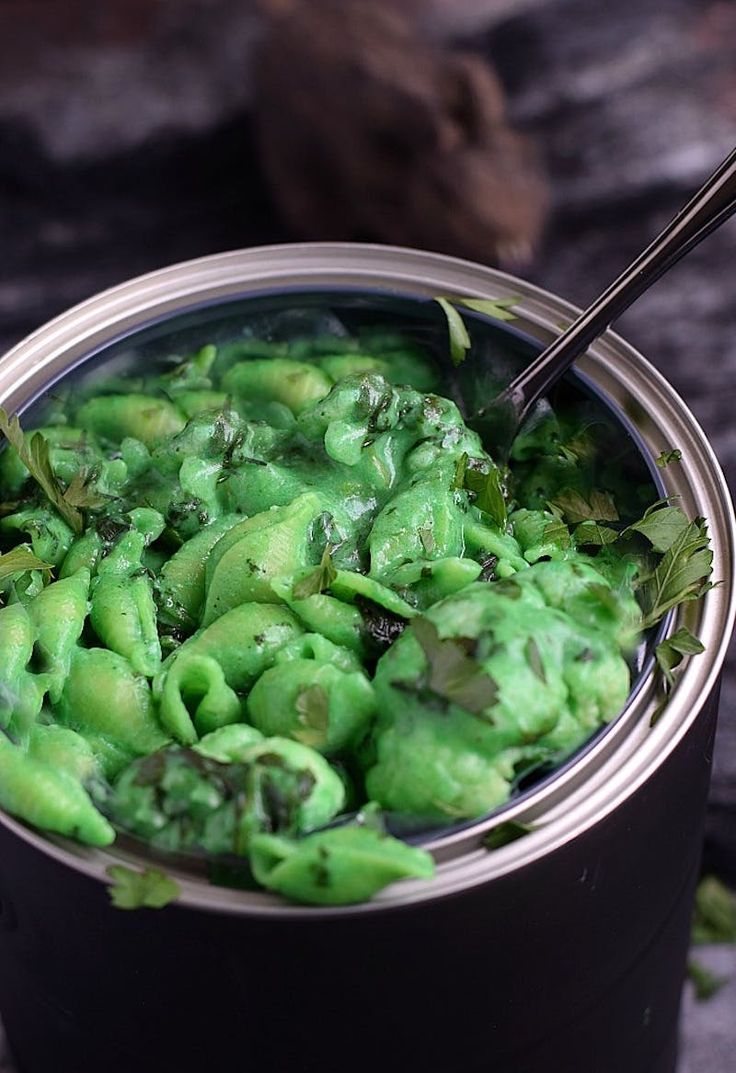 a pot filled with green food on top of a table