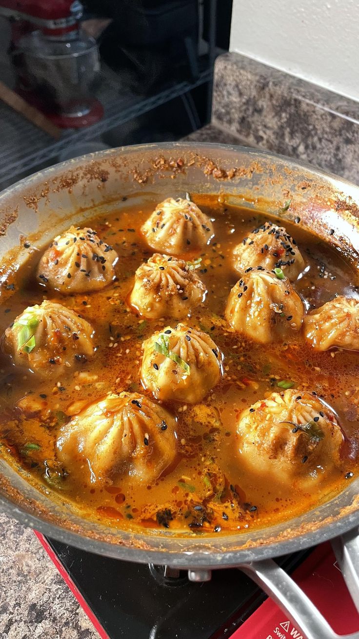 some dumplings are cooking in a pot on the stove